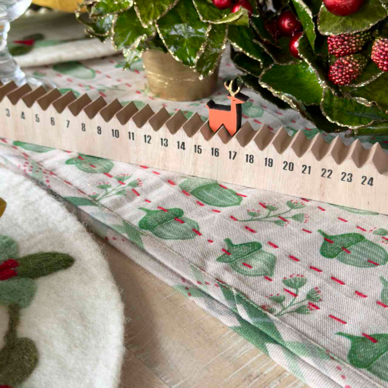 Close-up of a Christmas-themed gift with a decorative reindeer figure and patterned paper.