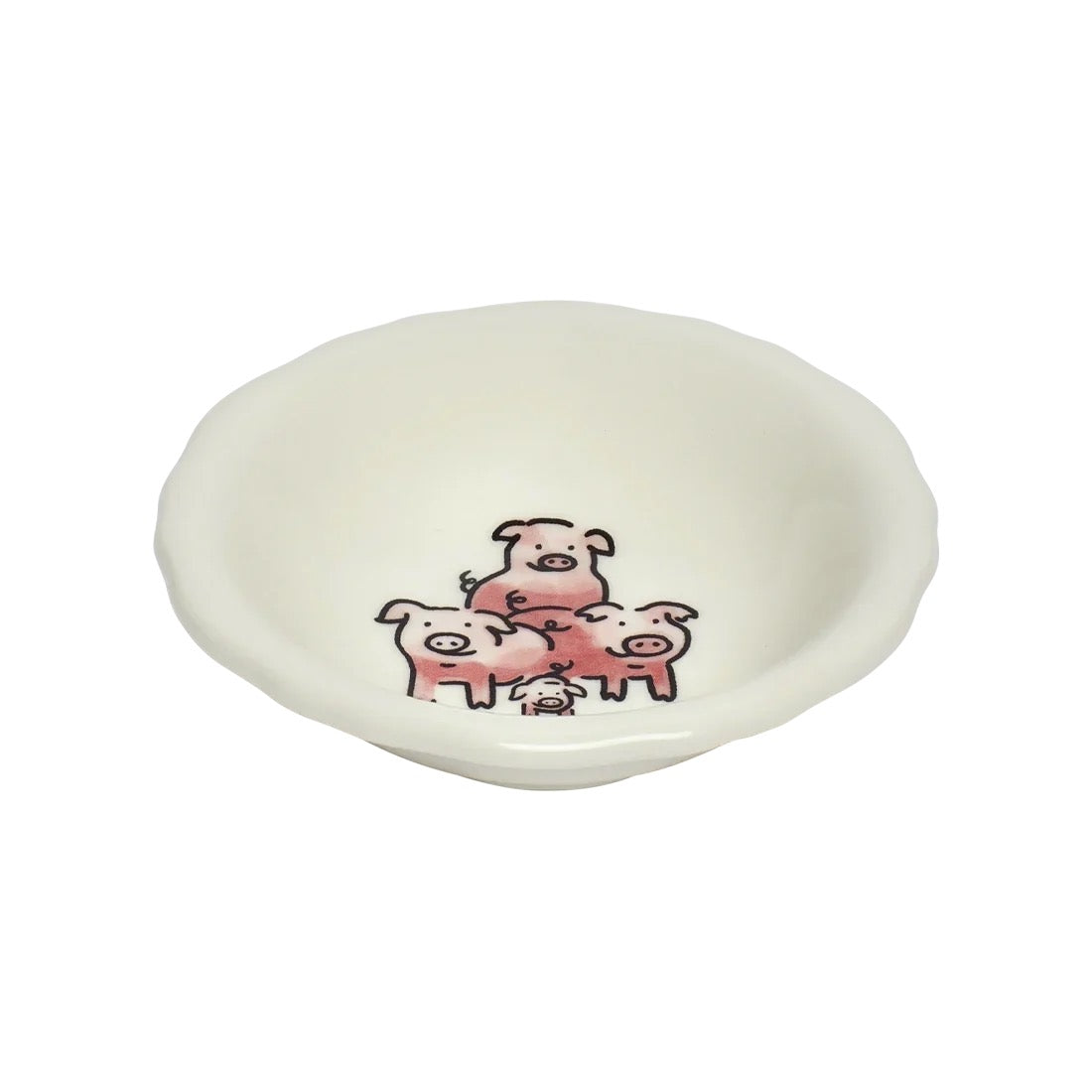 A small, scalloped-edge ceramic bowl in a warm off-white or cream color, decorated with a cute cartoon illustration of three pink pigs at the bottom center.
