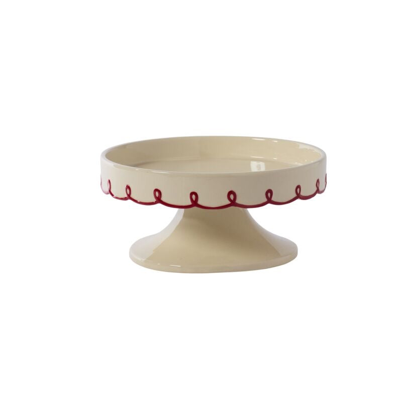 Beige ceramic cake stand with red decorative edge on a white background