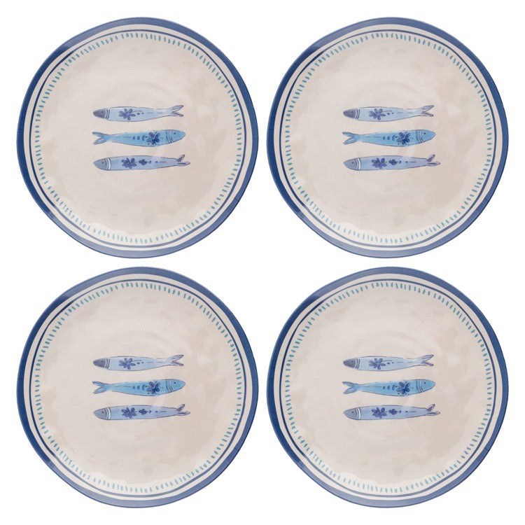 Set of four ceramic plates with blue fish design on a white background