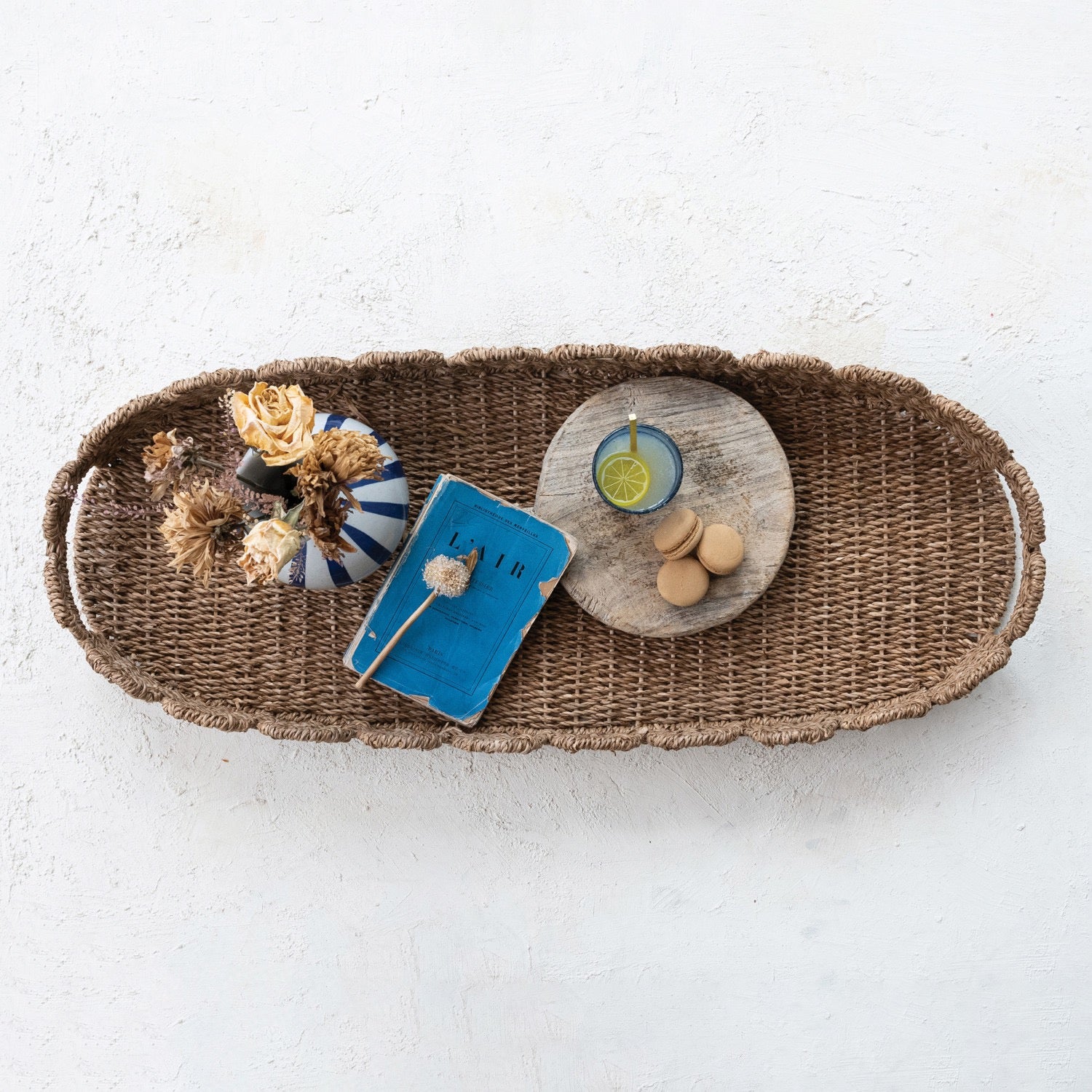 Wicker tray with decorative items on a light background