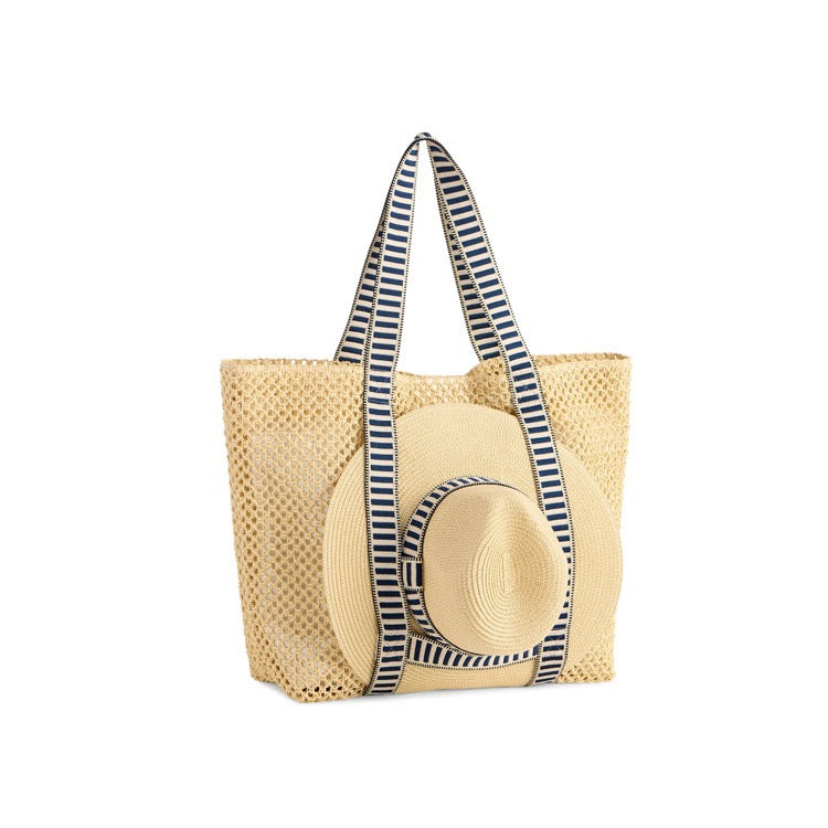 Woven tote bag with a straw hat and striped handle on a white background