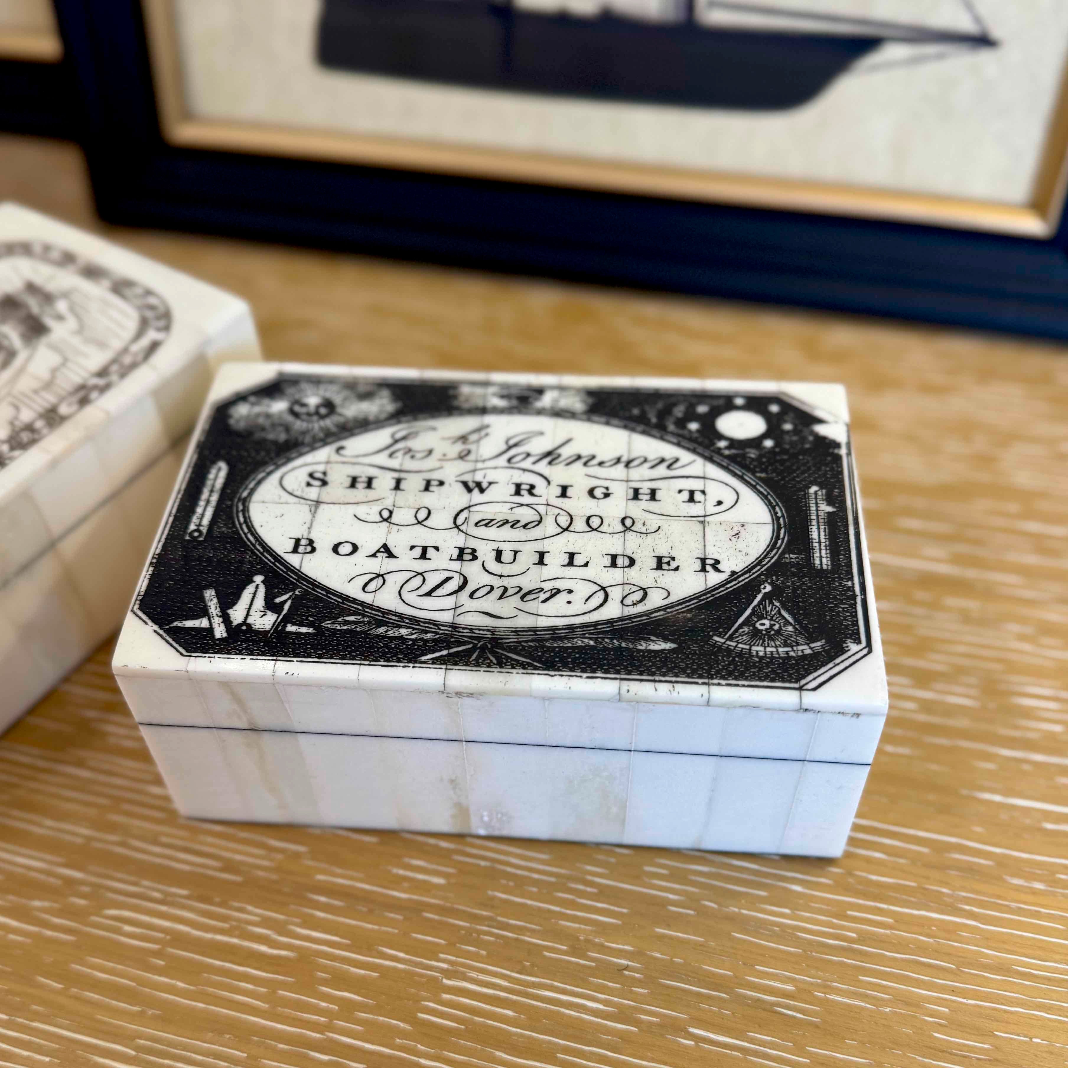 Wooden box with vintage shipwright label on a wooden surface