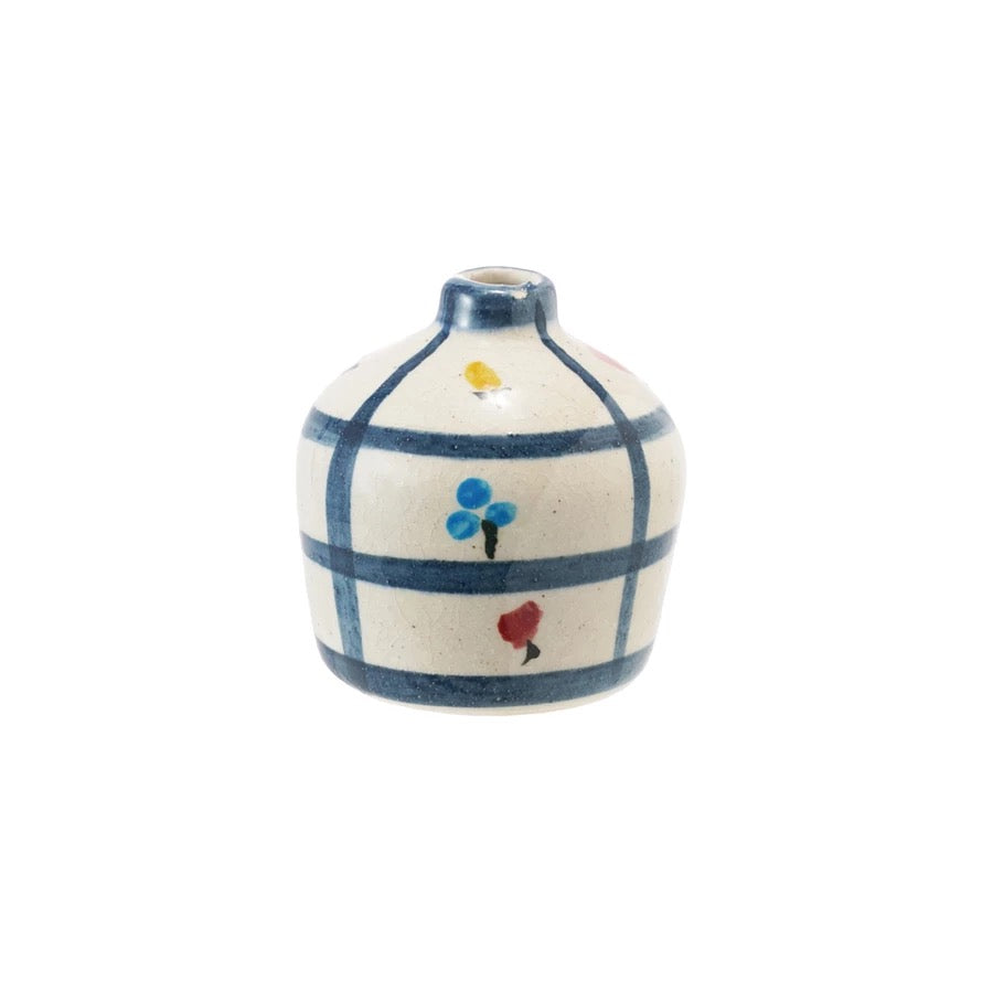 Small ceramic vase with blue grid pattern and colorful flower design on a white background
