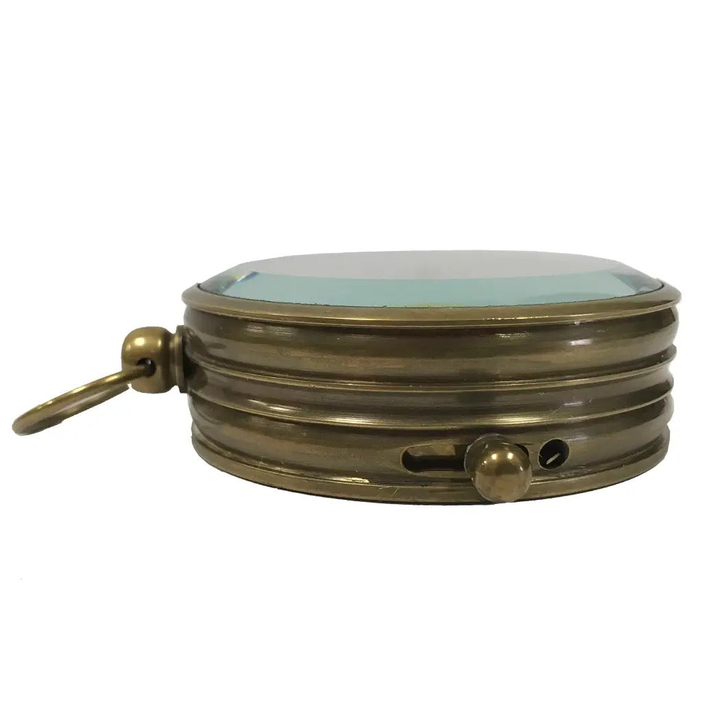 Brass compact mirror on a white background
