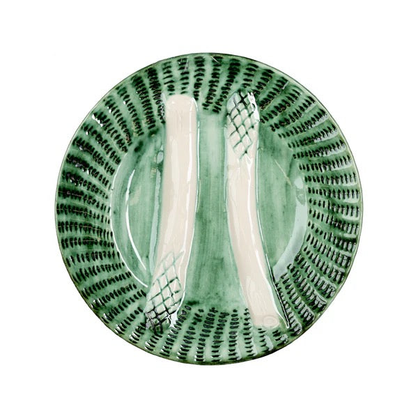 A round ceramic plate with a textured green and white design, featuring a central recessed area with two vertical white handles or handles-like inlays, photographed on a solid white background.