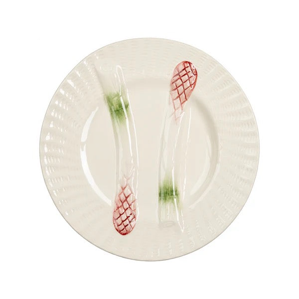 A white ceramic plate with a fluted rim, featuring two clear plastic utensils embedded in the center, each with a red grid pattern and a green translucent section.