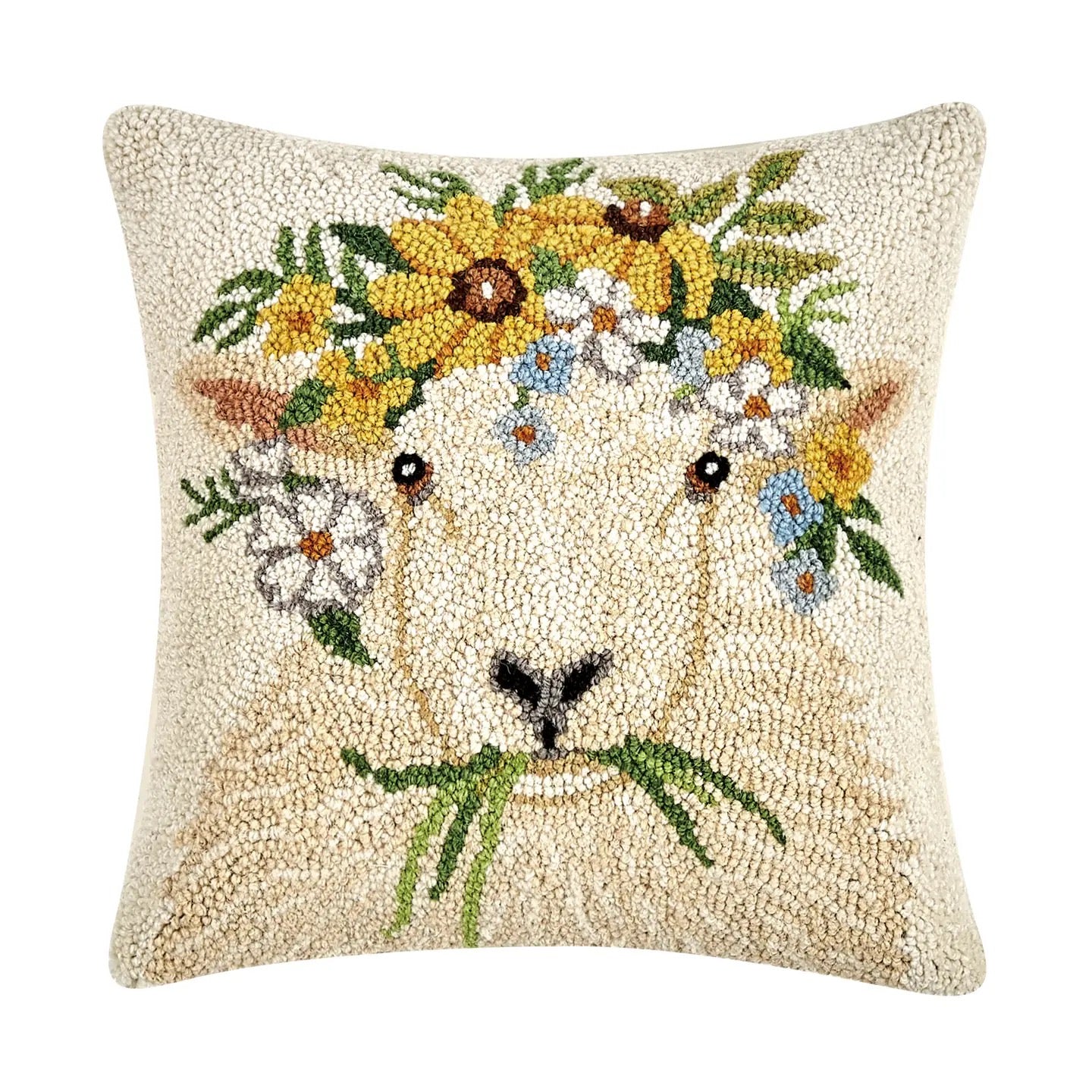 Decorative pillow with a goat face design and floral wreath on a white background