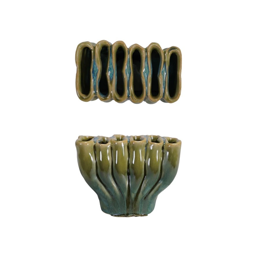 Ceramic vase with ribbed design on a white background