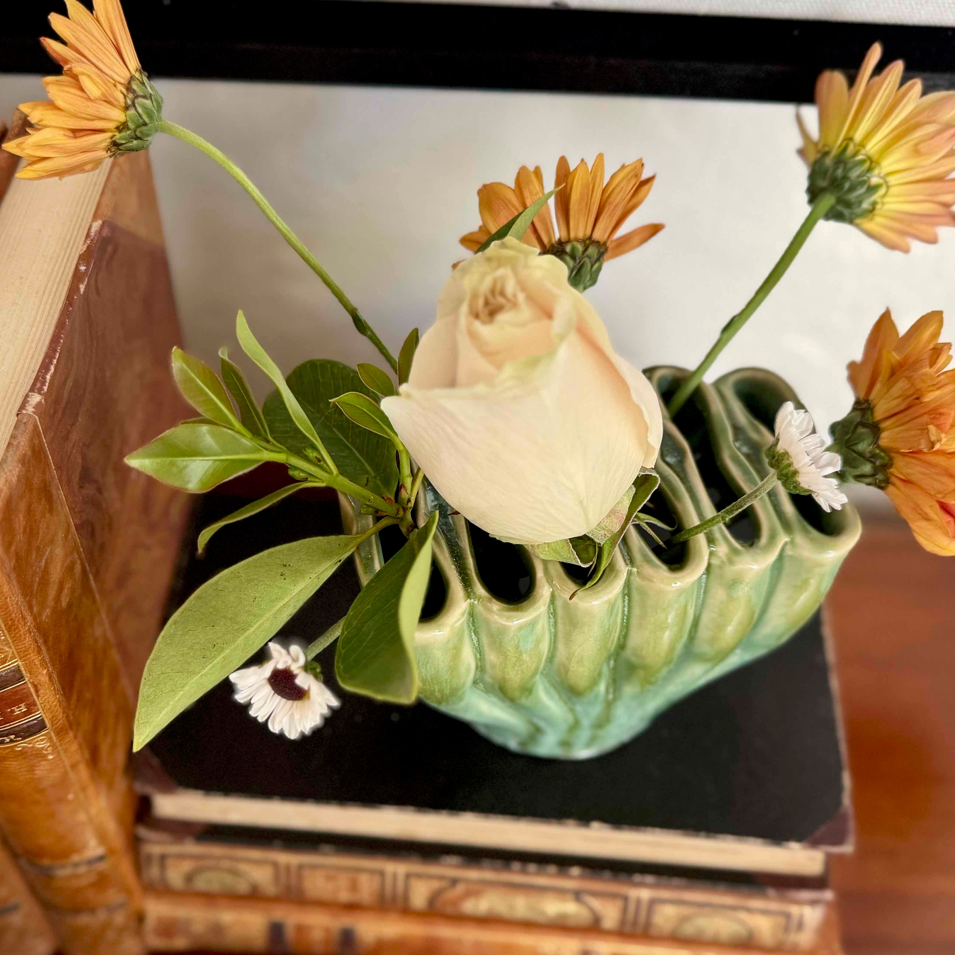 Vase with flowers on a stack of books