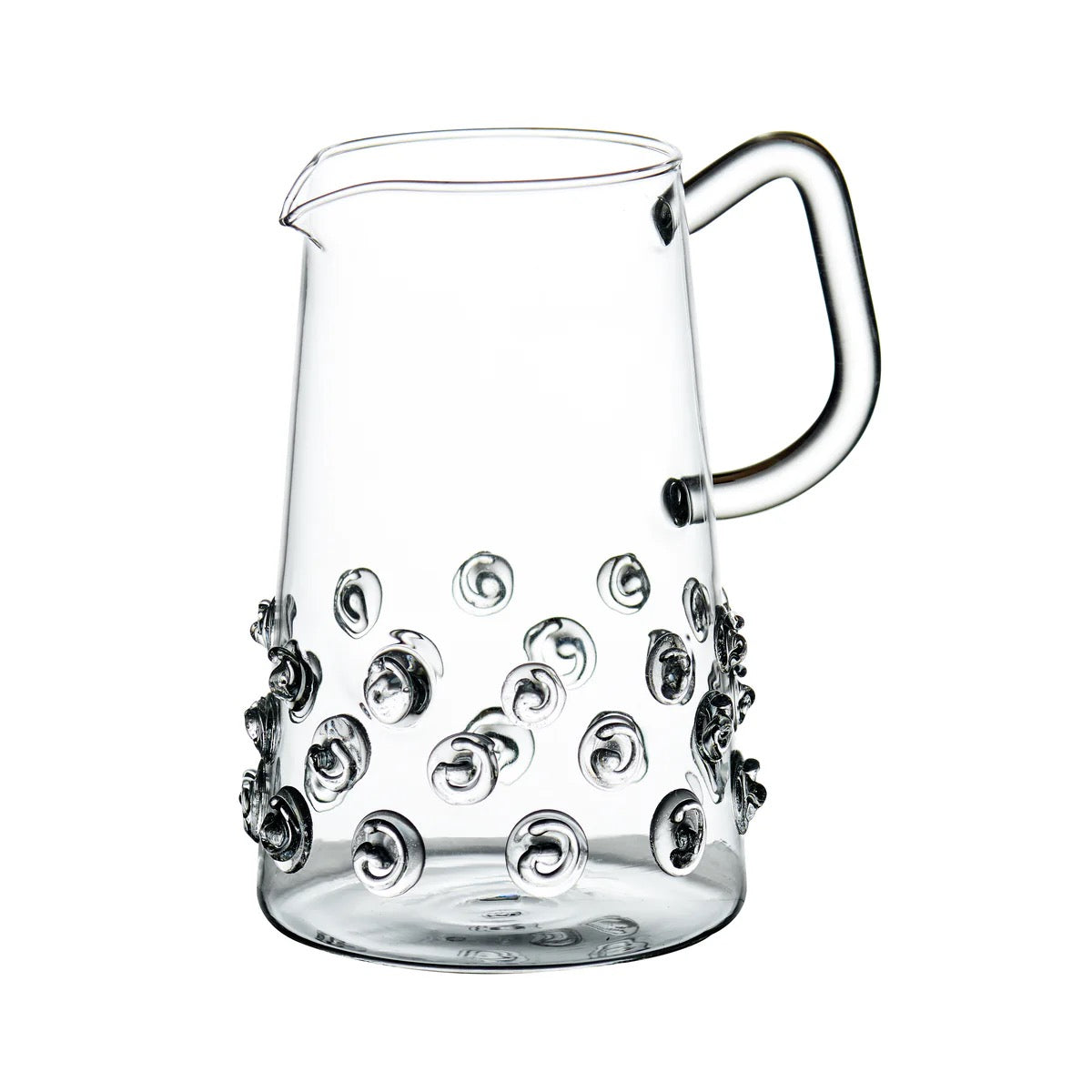 Clear glass pitcher with decorative swirl patterns on a white background