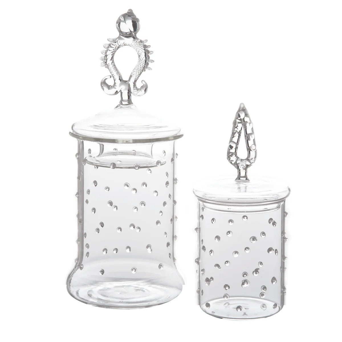 Two clear glass jars with decorative lids on a white background