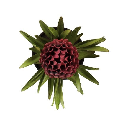 An artificial protea-style floral arrangement with a deep burgundy center and green radiating leaves, shown against a plain white background.