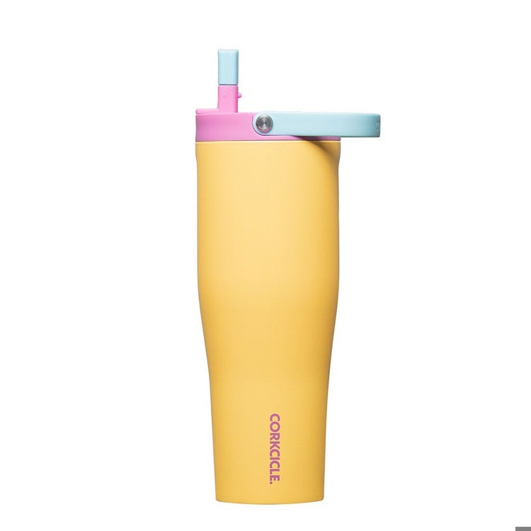 Yellow tumbler with pink and blue lid on a white background