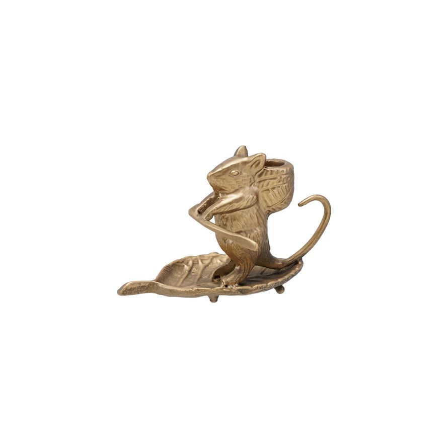 Bronze squirrel figurine with a nut on a white background