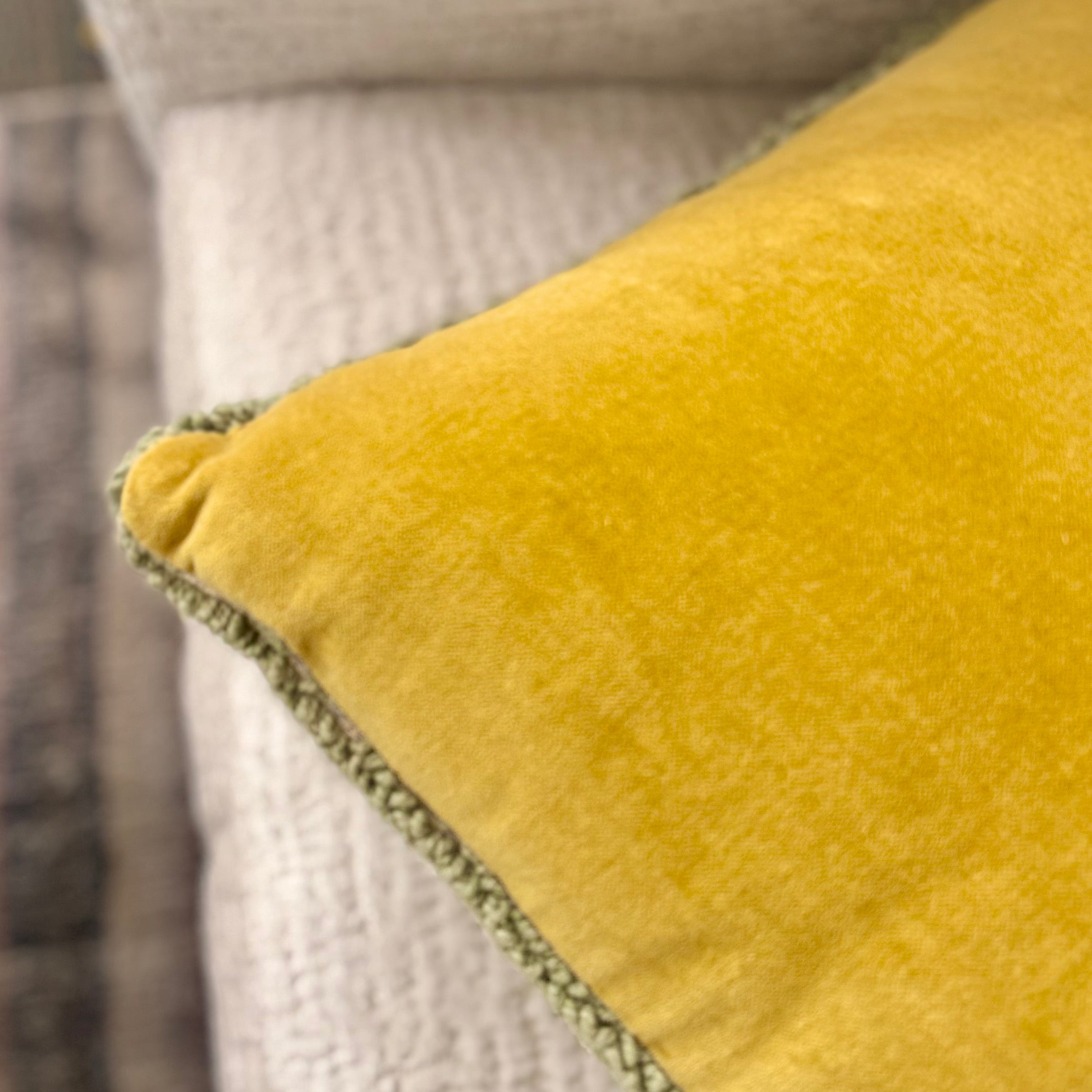 Close-up of a yellow textured pillow with a blurred background