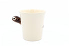 White ceramic mug with a brown handle on a white background