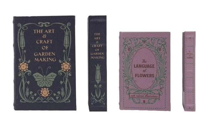 Set of four book-shaped coasters with decorative designs on a white background