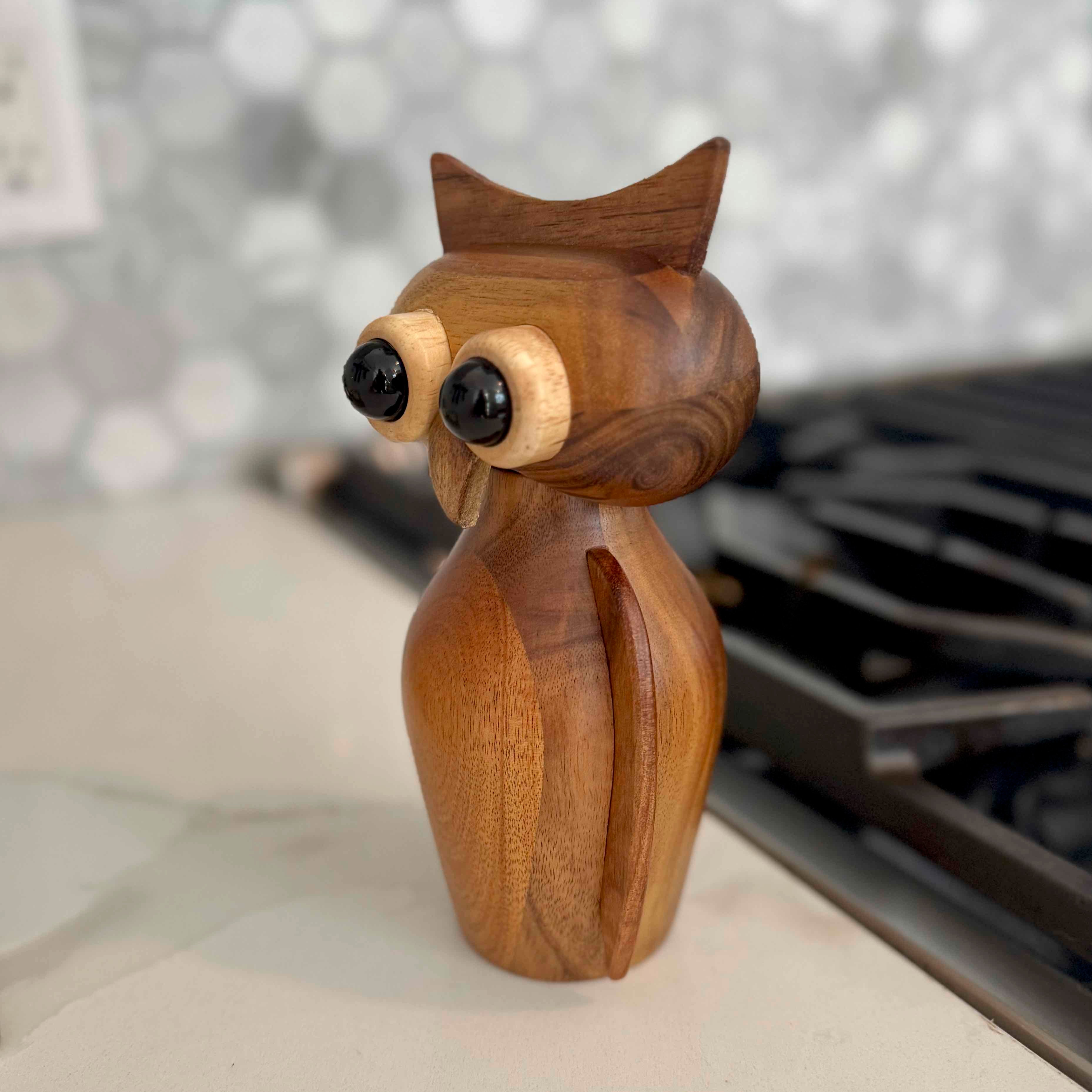 Wooden owl figurine on a blurred background