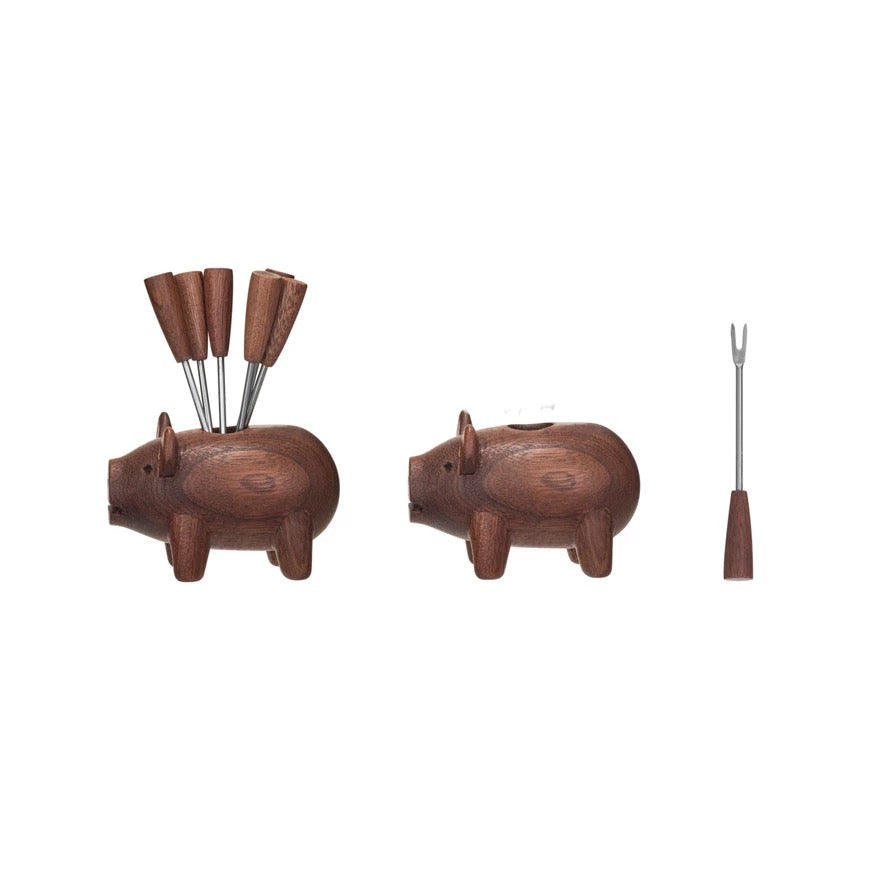 Wooden pig-shaped holder with skewers on a white background
