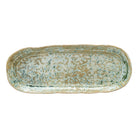 Oval ceramic tray with a textured surface on a white background
