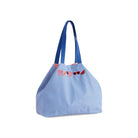 Blue striped tote bag with decorative elements on a white background