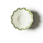 Small white bowl with green rim on a white background