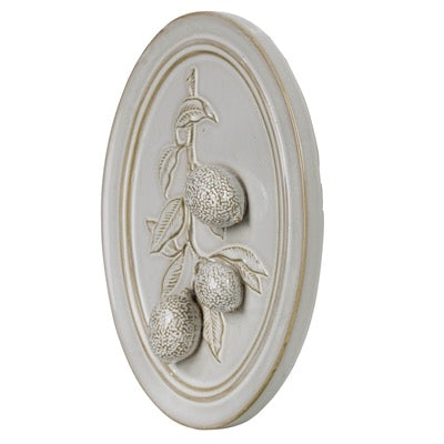Decorative wall plaque with fruit design on a white background
