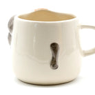 White ceramic mug with gray elephant design on a white background
