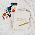 Grandparent Memory Book with pen and photos on a textured surface