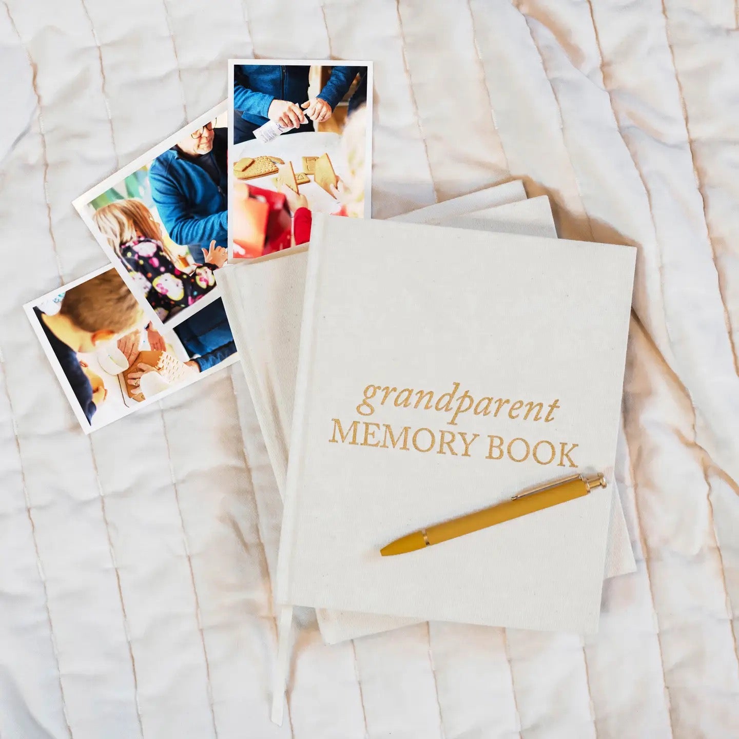 Grandparent Memory Book with pen and photos on a textured surface