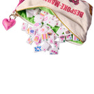 Colorful children's tiles with cartoon designs spilling out of a 'Bespoke Magic' bag.