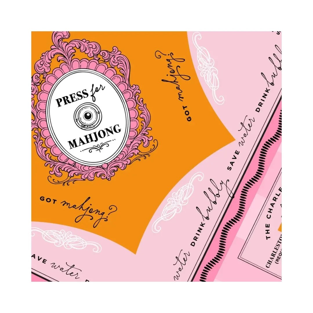 Packaging for Press for Mahjong game with decorative elements on an orange and pink background.