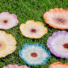 Colorful artificial flowers on grass