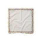 White napkin with decorative scalloped edge on a white background
