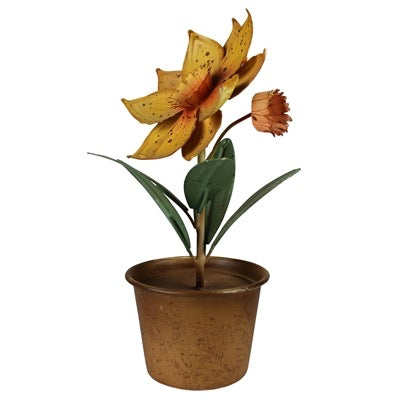 An artificial potted flower with a large yellow-orange lily-like bloom, a smaller orange bud, green leaves, and a textured brown pot on a plain white background.