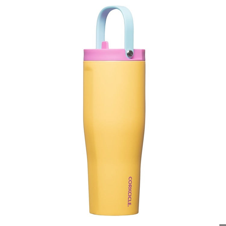 Yellow tumbler with a pink and light blue lid on a white background