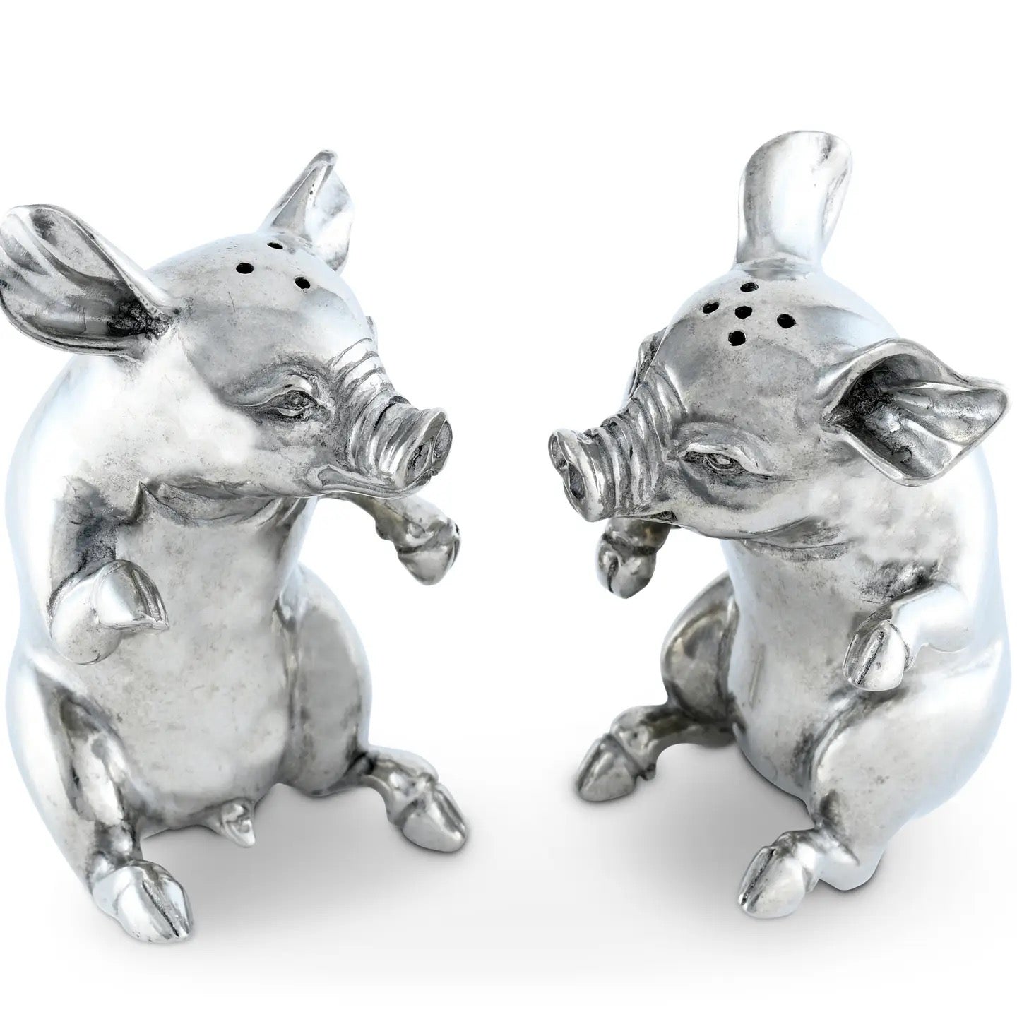 Two silver pig-shaped salt and pepper shakers on a white background
