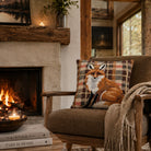 Cozy living room with a fireplace, armchair, and fox-patterned pillow.