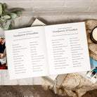 Open book with a list titled 'Grandparents & Grandkids' on a wooden surface.