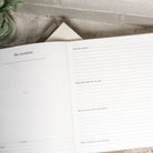 Open book with lined pages on a textured surface