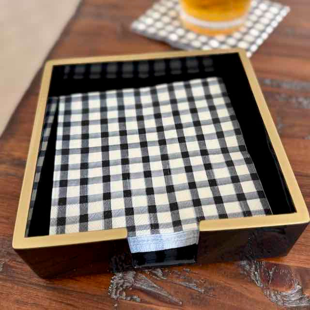 Black and white checkered cloth in a decorative box on a wooden surface.