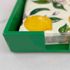 Set of napkins with lemon design in a green holder