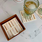 Set of coasters with a glass of beer on a marble surface