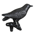 Black cast iron bird decorative item on a white background