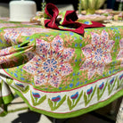 Colorful floral-patterned tablecloth on a table with a decorative bow.