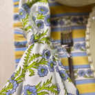 Colorful floral-patterned napkin with a striped fabric background