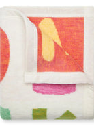 Folded fabric with colorful abstract pattern on a white background