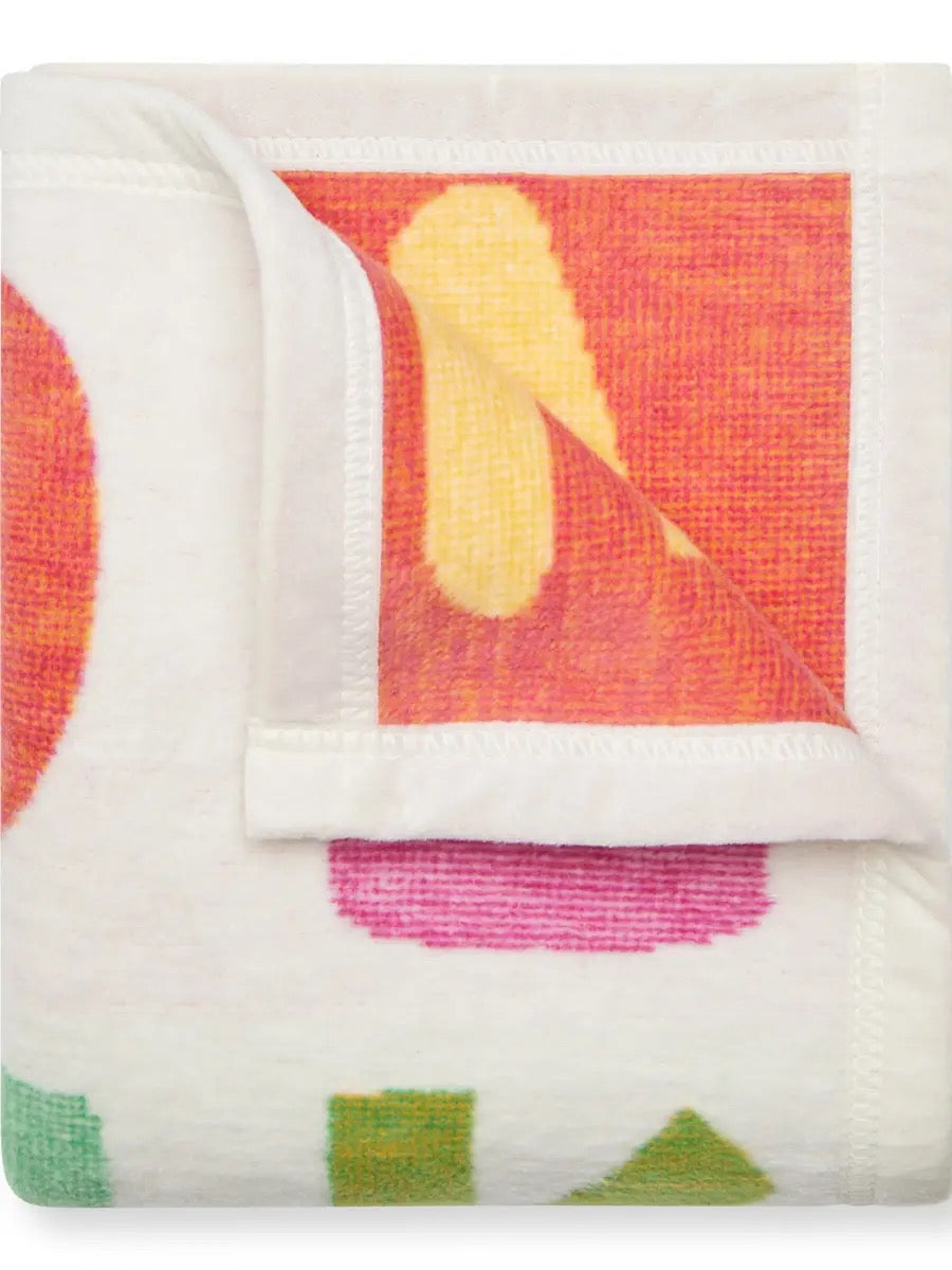 Folded fabric with colorful abstract pattern on a white background