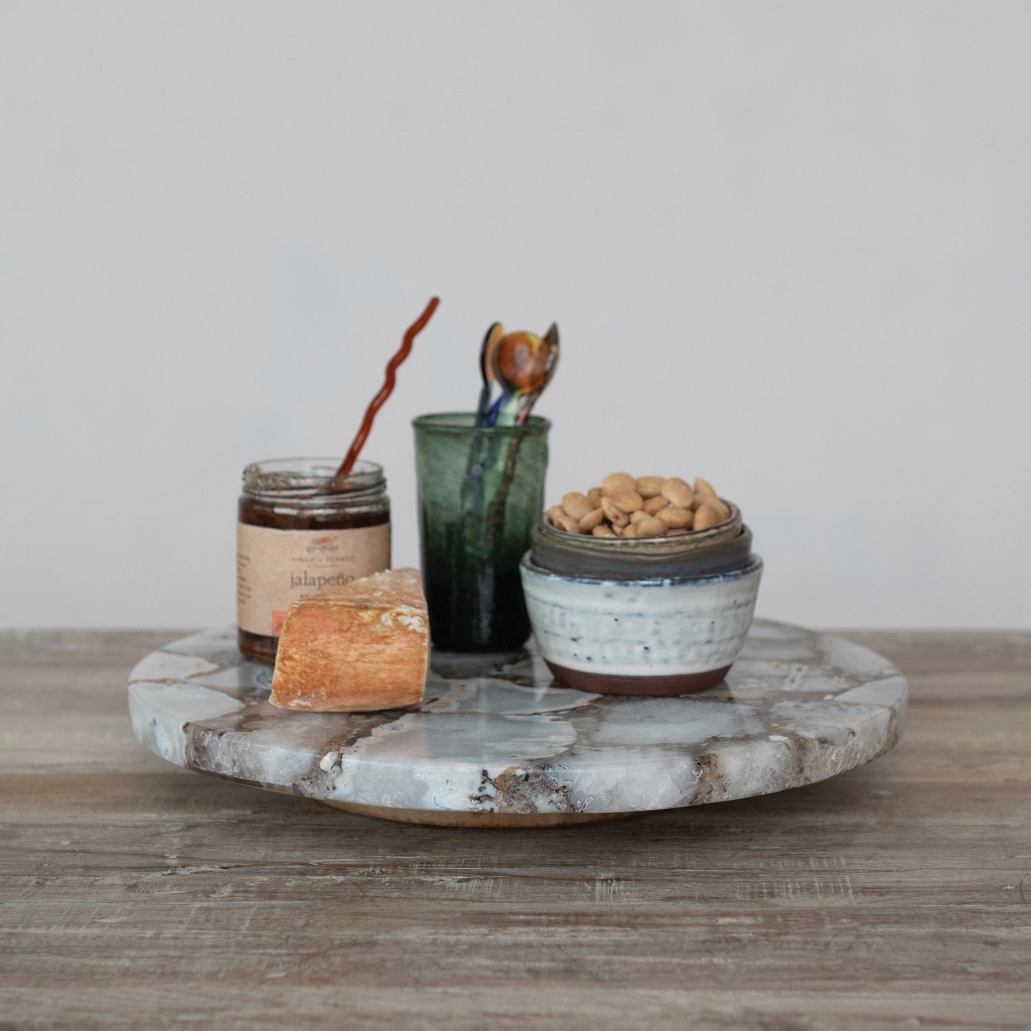 Decorative items on a marble tray with a neutral background